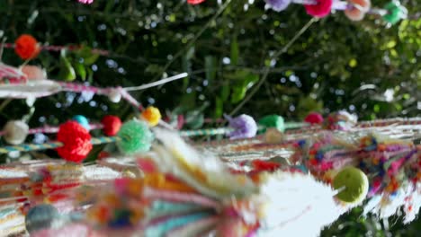 handmade dreamcatcher hanging on tree swaying in the wind