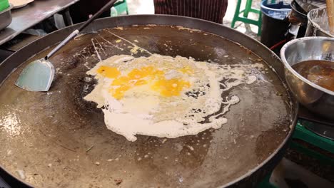 sequence of frying scrambled eggs in a pan.