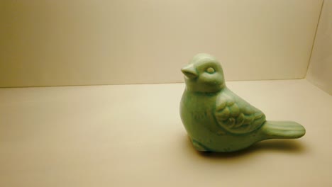 green ceramic bird decoration. pan movement