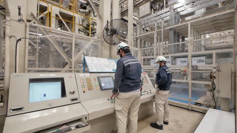 technician operate on control panel in factory, editorial