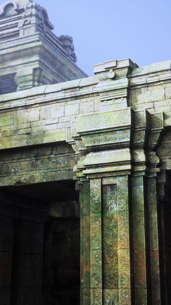 Ancient stone archway leads to mystical landscape with serene water