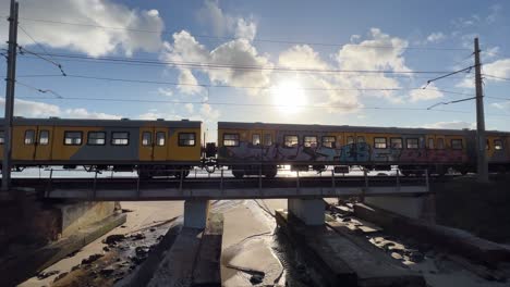 Train-going-over-bridge-next-to-coast