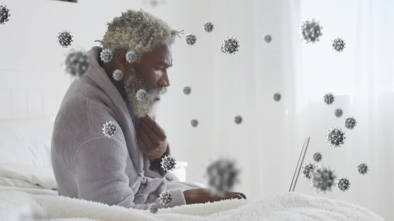 animación de células de virus sobre un hombre afroamericano usando una computadora portátil