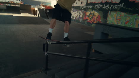 active teenager skateboarding at skate park. close up man riding on skate board