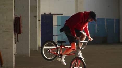 bmx rider in an empty warehouse