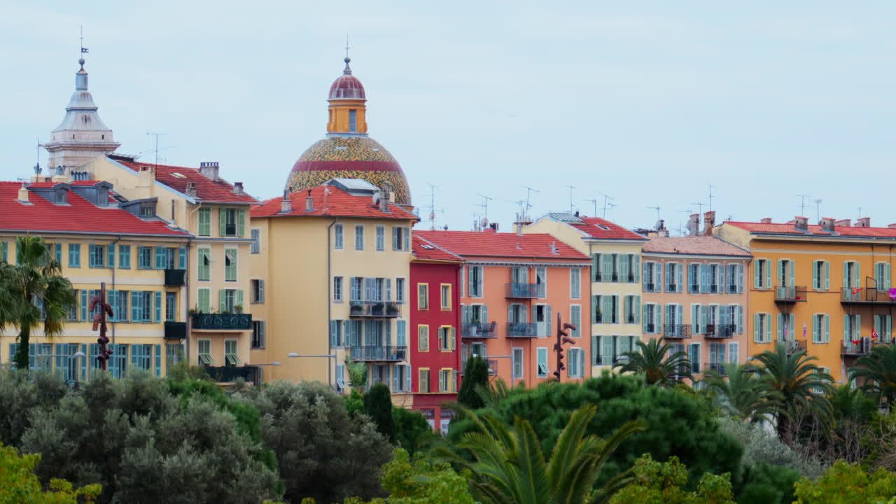 Colourful buildings and trees in the skyline of Nice, France on a cloudy day