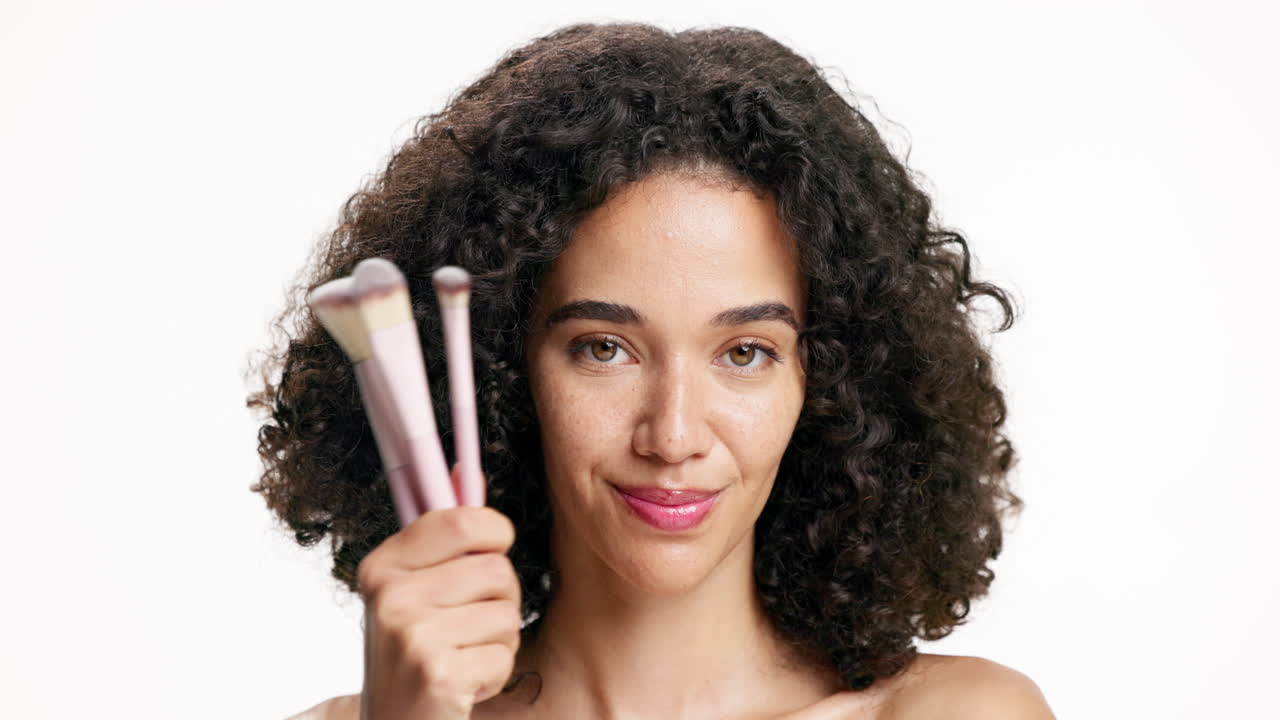 Woman holding makeup brushes