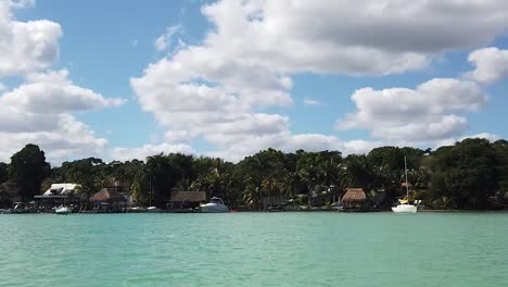 tropical-village-in-Bacalar-shoreline-in-the-Riviera-Maya,-Quintana-Roo,-Mexico