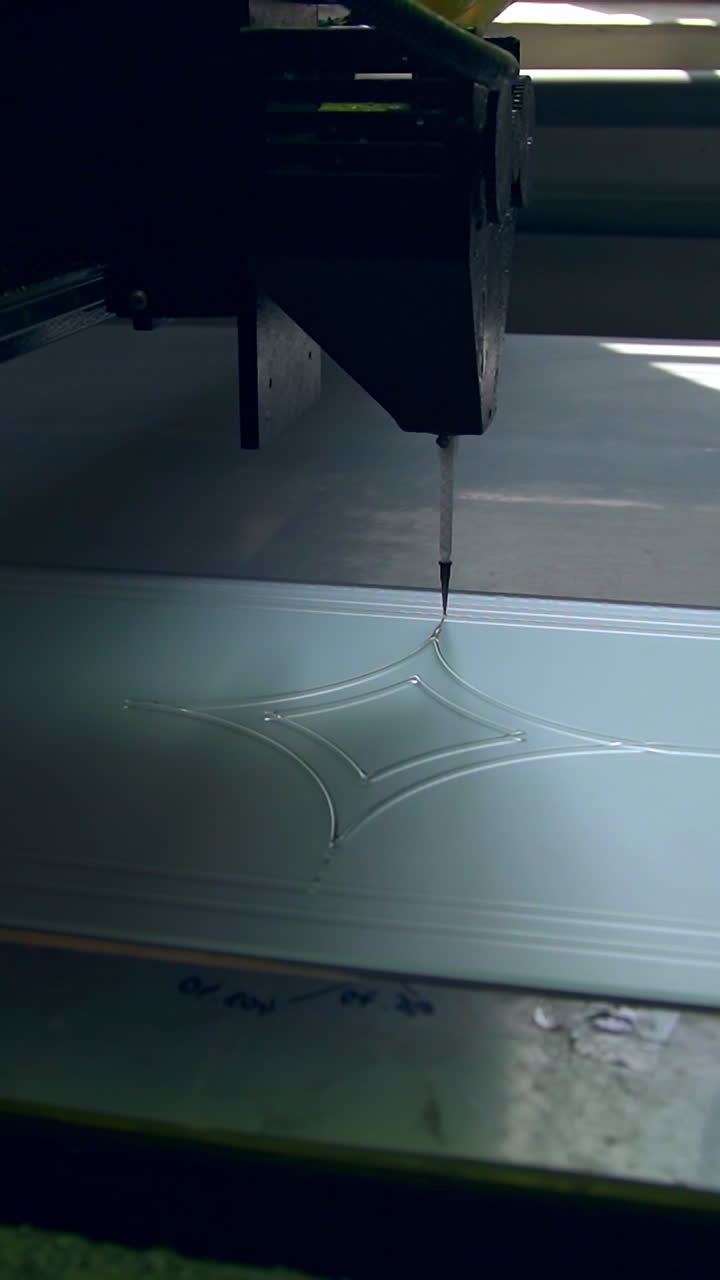 Special equipment for making décor at glass door. Automated machine moves leaving the picture on the glass surface. Vertical video