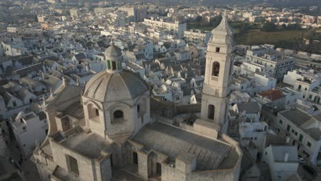 Drone-Volando-Sobre-La-Ciudad-Medieval-Locorotondo-Revela-La-Cúpula-Y-La-Torre-De-La-Iglesia-Madre-De-San-Giorgio-Mártir