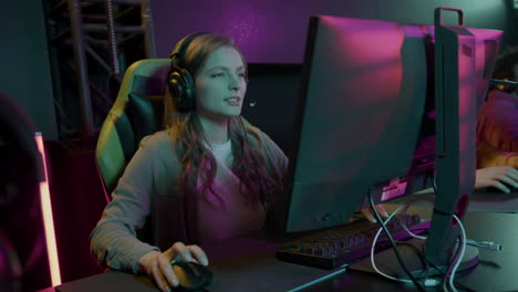 concentrated cybersport female gamer playing virtual video games and feeling upset because of losing the game