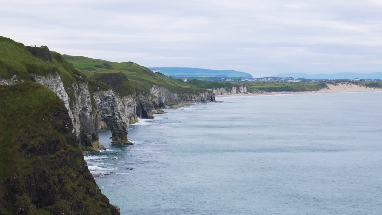Gloomy weather skies dawning white rocks cliff Portrush Northern Ireland