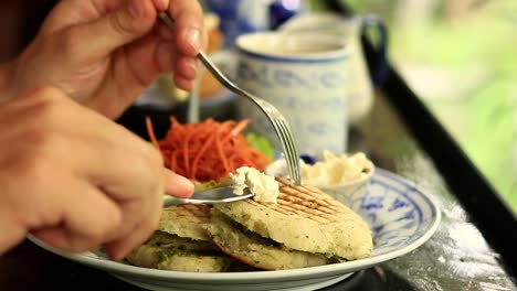 Close-up-to-a-vegan-panini-being-topped-with-coconut-cream-for-a-healthy-breakfast