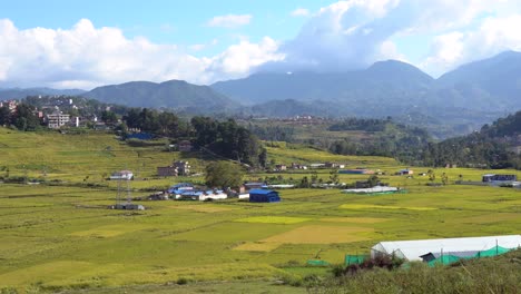 a beautiful landscape view of the terraced hillsides and mountains of nepal on a sunny day