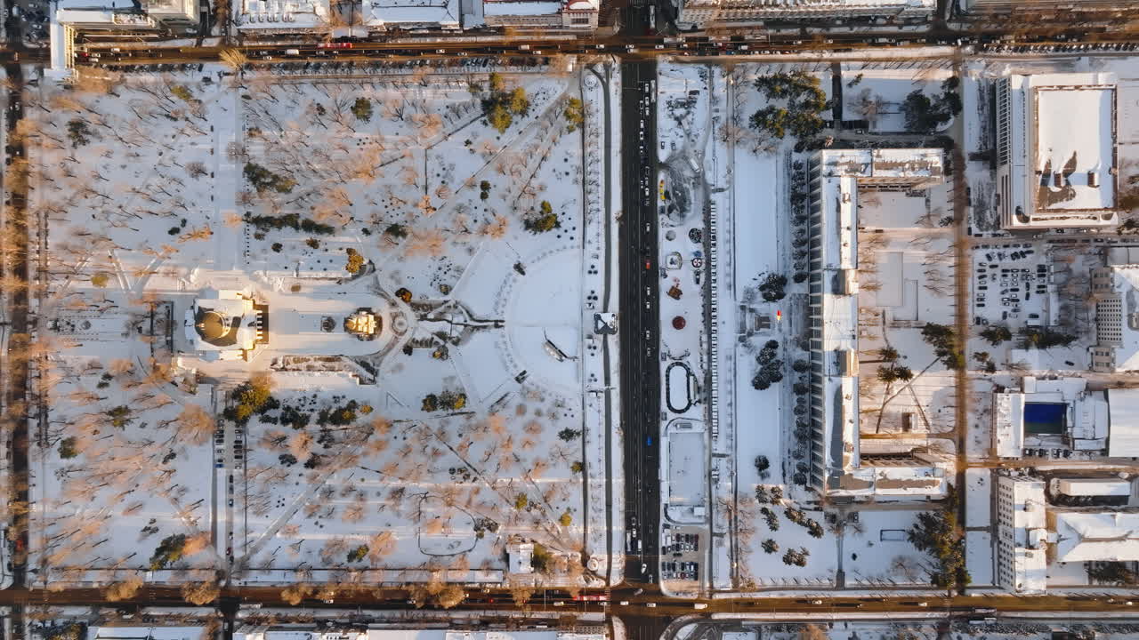 Aerial drone top view of the Bell tower and the Metropolitan Cathedral of Christ's Nativity. City center covered in snow at sunset in Chisinau, Moldova