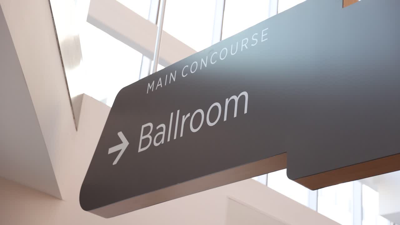 Interior shot of a “Ballroom” sign within a convention center. Directional signage indicating event or meeting space. Clean, professional setting