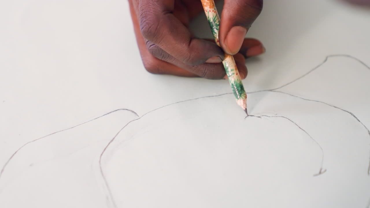 Black hand sketching flower outline on paper, closeup of black artist preparing painting study with pencil dotted guide, graphite smudges on fingertips, soft studio light, patient creative focus
