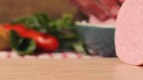 ham italian mordatella, man slices of traditional italian antipasti mortadella sausage on a wooden cutting board, close up macro of chicken or turkey jamon, fat breakfast dish.