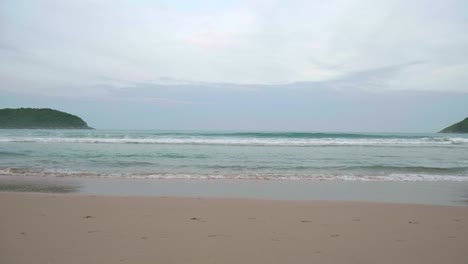 Ocean-waves-breaking-into-the-shore-on-the-beach-in-Phuket,-Thailand