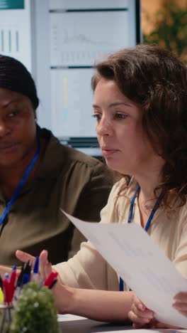 vertical video empowered businesswomen evaluating graphs and strategy reports