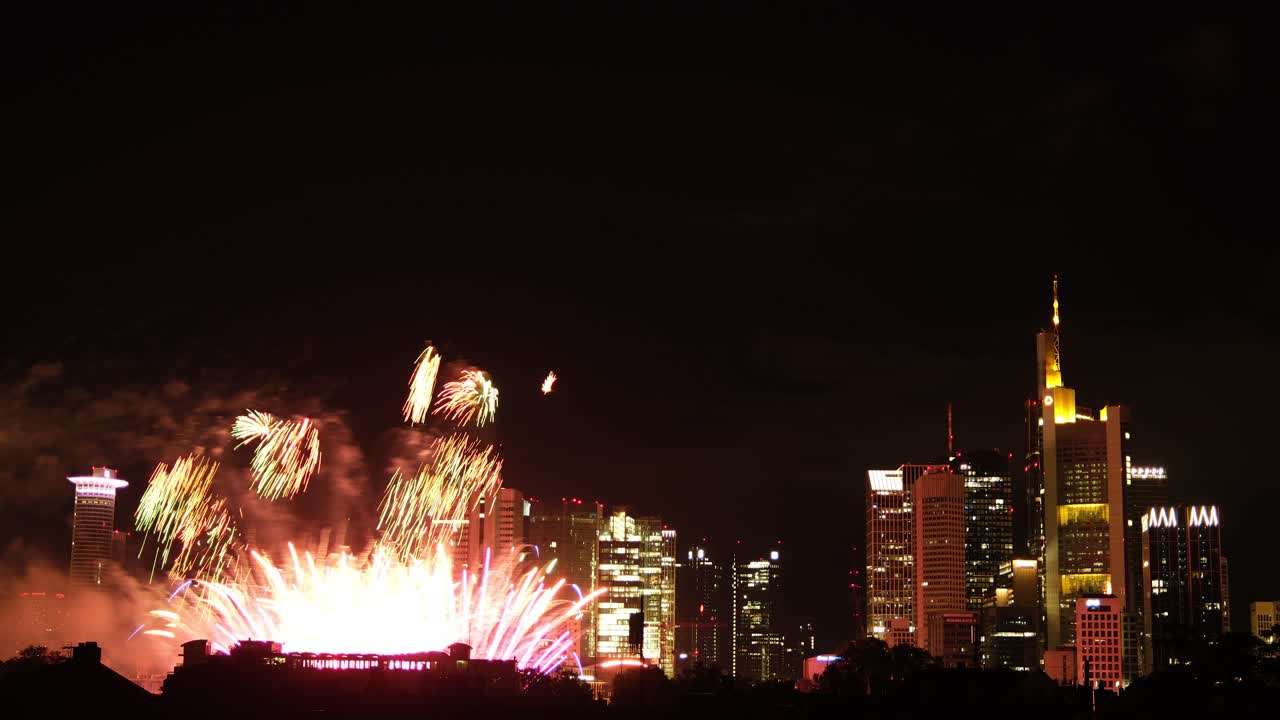 Fireworks illuminate Frankfurt night skyline timelapse, joyful celebration