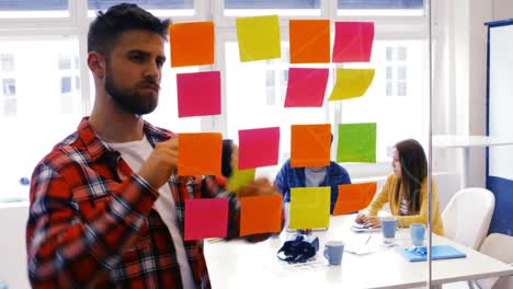 graphic designer reading sticky notes