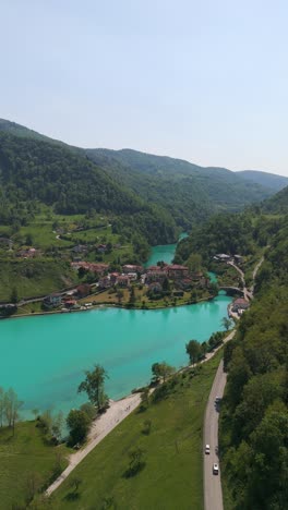most na soči - picturesque town on confluence of soca and idrijca rivers in slovenia. aerial shot, vertical
