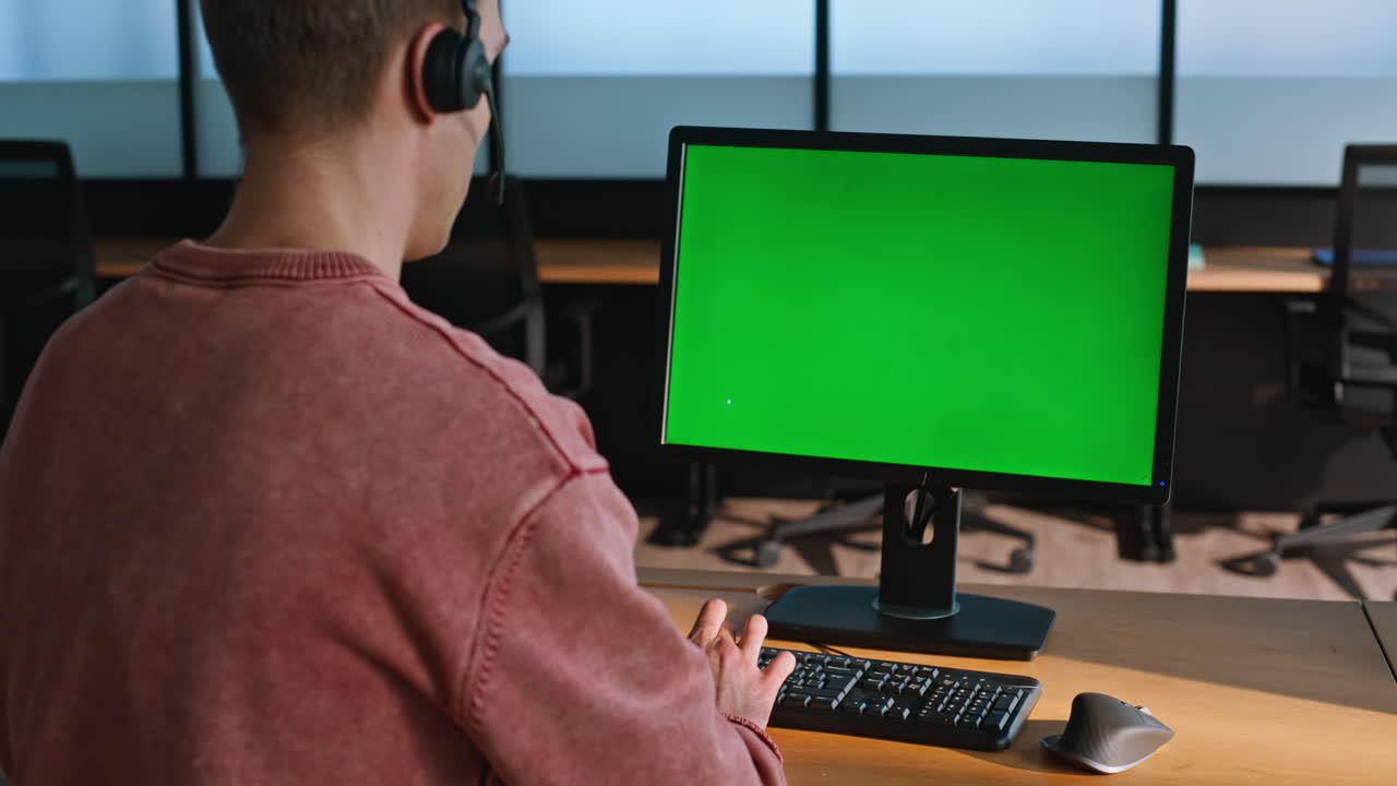 Operator using chromakey computer at workplace closeup. Green screen device