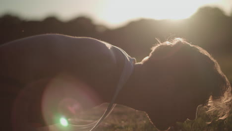 Close-Up-Shot-of-Young-Attractive-Man-Doing-Push-Ups-In-The-Park-During-Golden-Hour