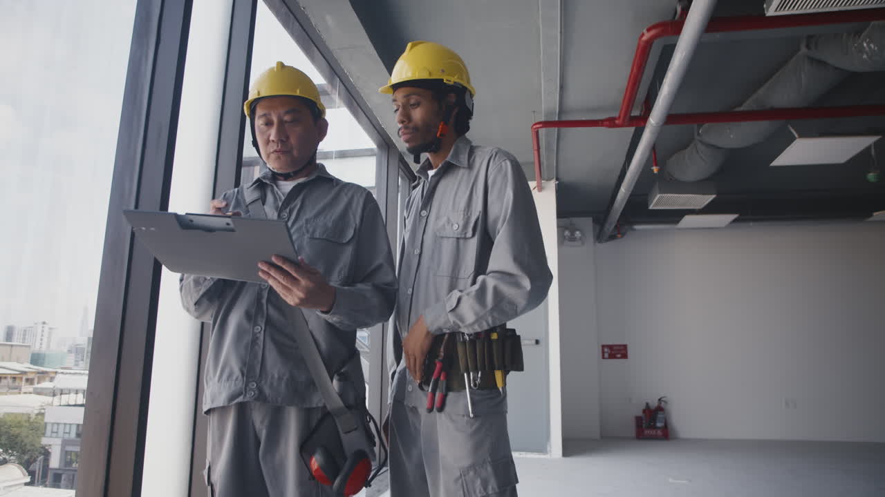 Builders in Uniform Discussing Construction Plan