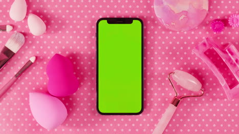 pink makeup and beauty items with phone