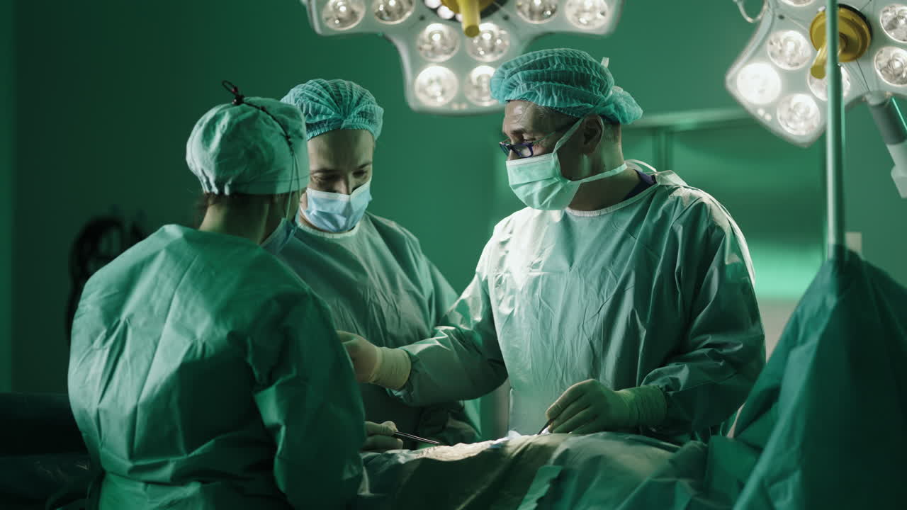 Surgical team performing an operation in a hospital operating room