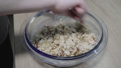 woman-mixes-crumpled-tofu-with-spices-and-egg-with-a-fork