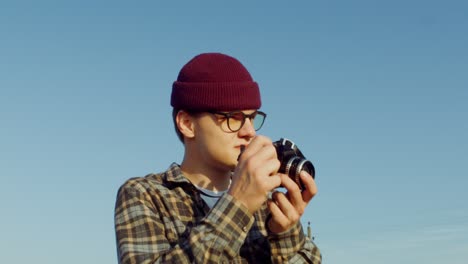 man taking photo with vintage camera