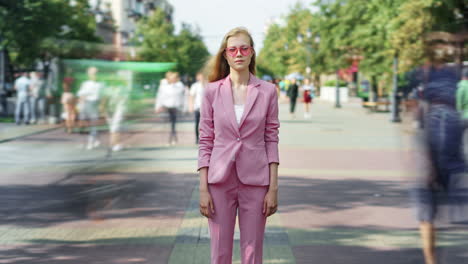 woman in pink suit on a city street