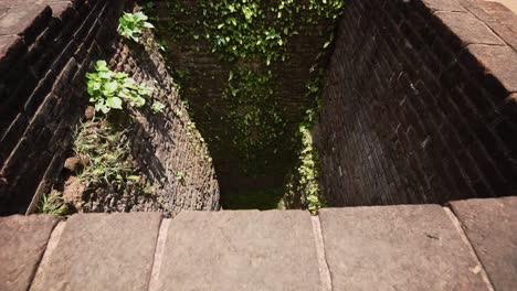 View-into-an-ancient-fountain-in-the-ruined-city-and-archaeological-site-of-Anuradhapura,-Sri-lanka