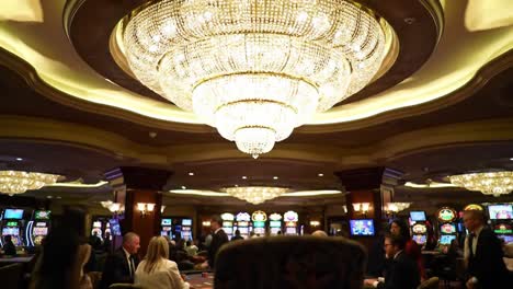 an elegantly designed casino interior featuring an opulent chandelier illuminating the atmosphere in a vibrant gaming environment