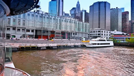setting off on the boat from the pier in new york, usa. riverboat tour by modern metropolis
