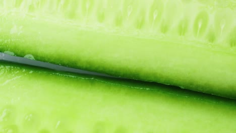 top view of fresh sliced cucumber rotation. 4k macro