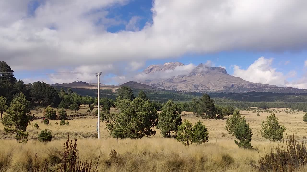A view of Iztaccihuatl mountain from far away on a sunny day