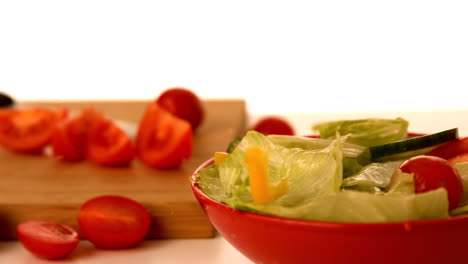 fresh salad falling into bowl