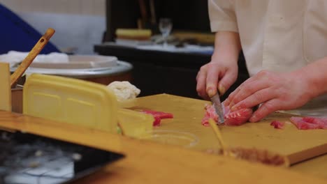 sushi chef preparing chutoro nigiri at omakase course in tokyo, japan
