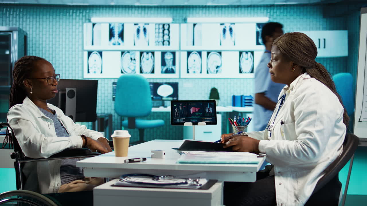 African american doctor and patient with disability engaging in detailed checkup
