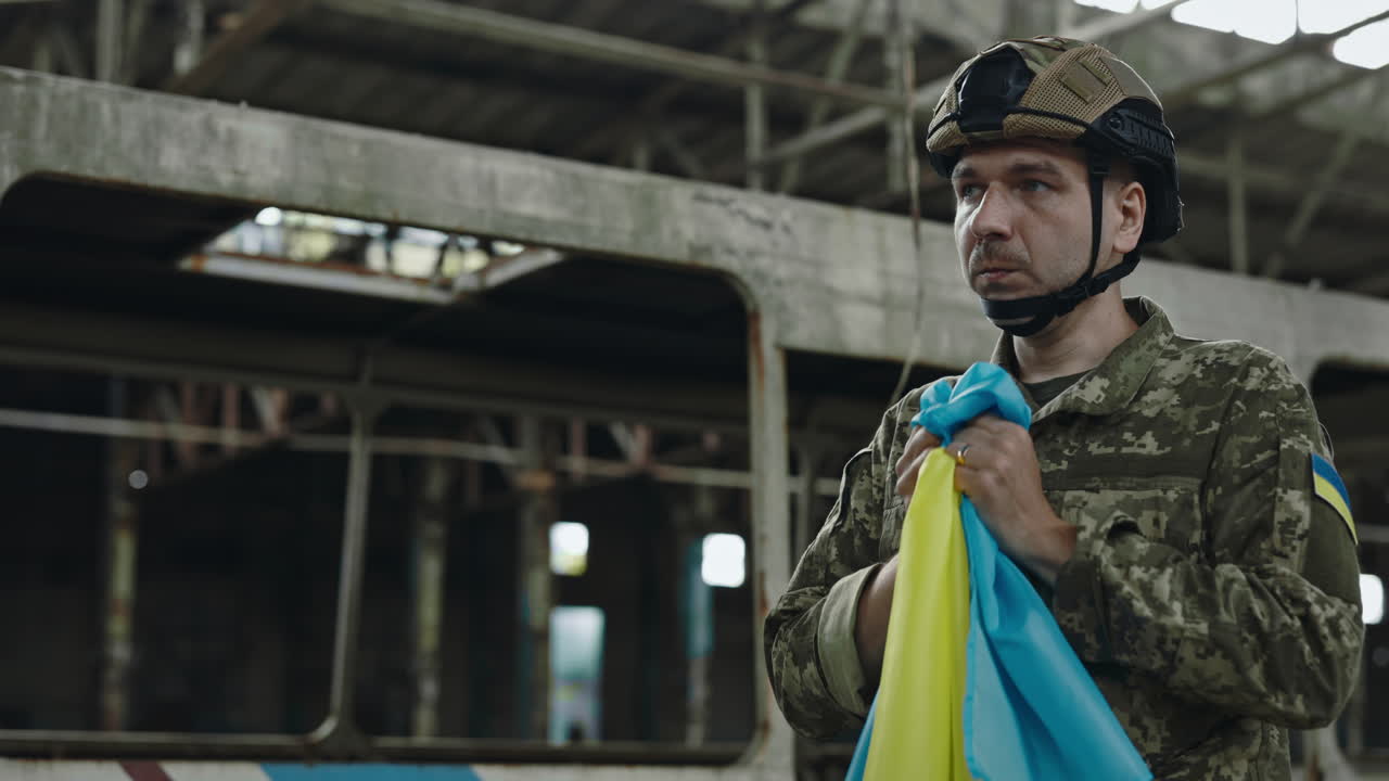 Ukrainian soldier mourning in a war zone