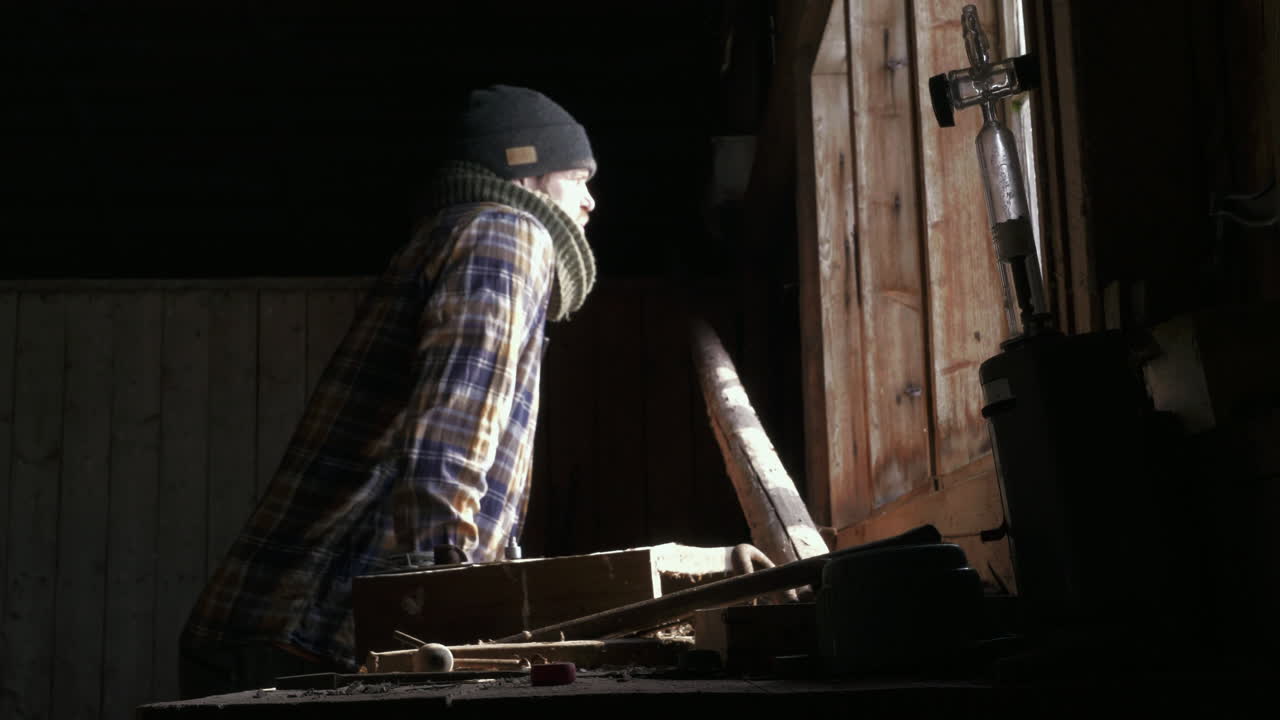 Uomo alla postazione di lavoro in legno con pensieri di distrazione mentale, basso, medio.