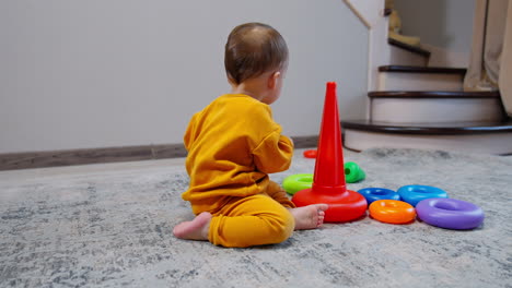 baby playing with stacking toys