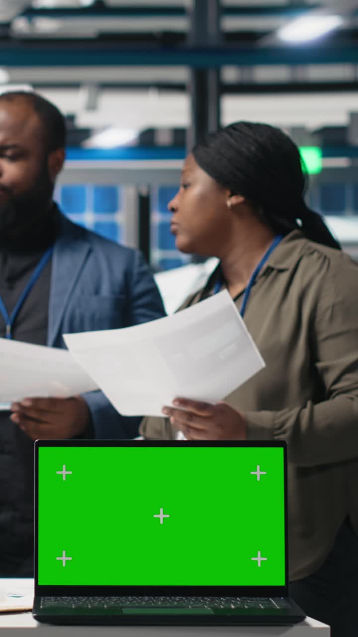 Vertical Video Team of consultants and factory analysts work with a copy space screen