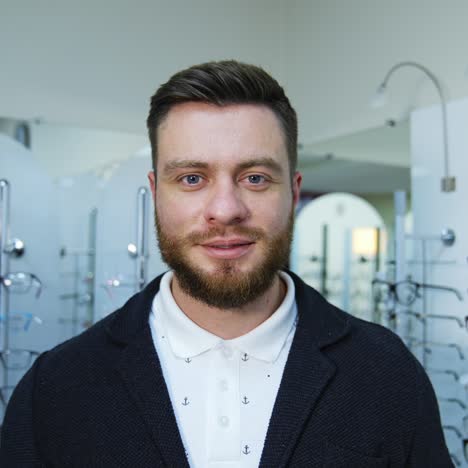 man in optical shop choosing eyeglasses