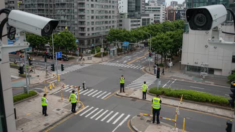 urban surveillance: law enforcement monitors intersection with advanced camera systems and officers maintaining traffic control in a modern city environment