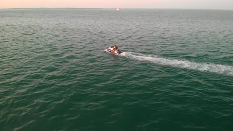 Drone-Siguiendo-Un-Crucero-En-Moto-De-Agua-En-Mar-En-Calma,-Golfo-Pérsico-Abu-Dhabi